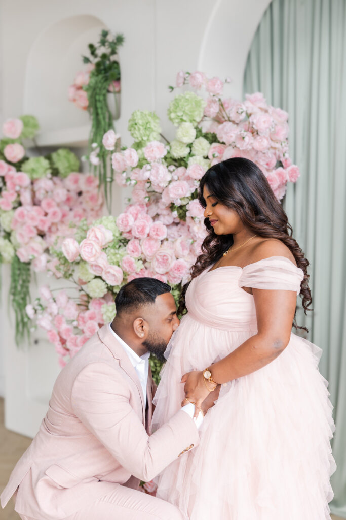 Husband holding wife's pregnant belly during Mint Room Studios Maternity Session Toronto